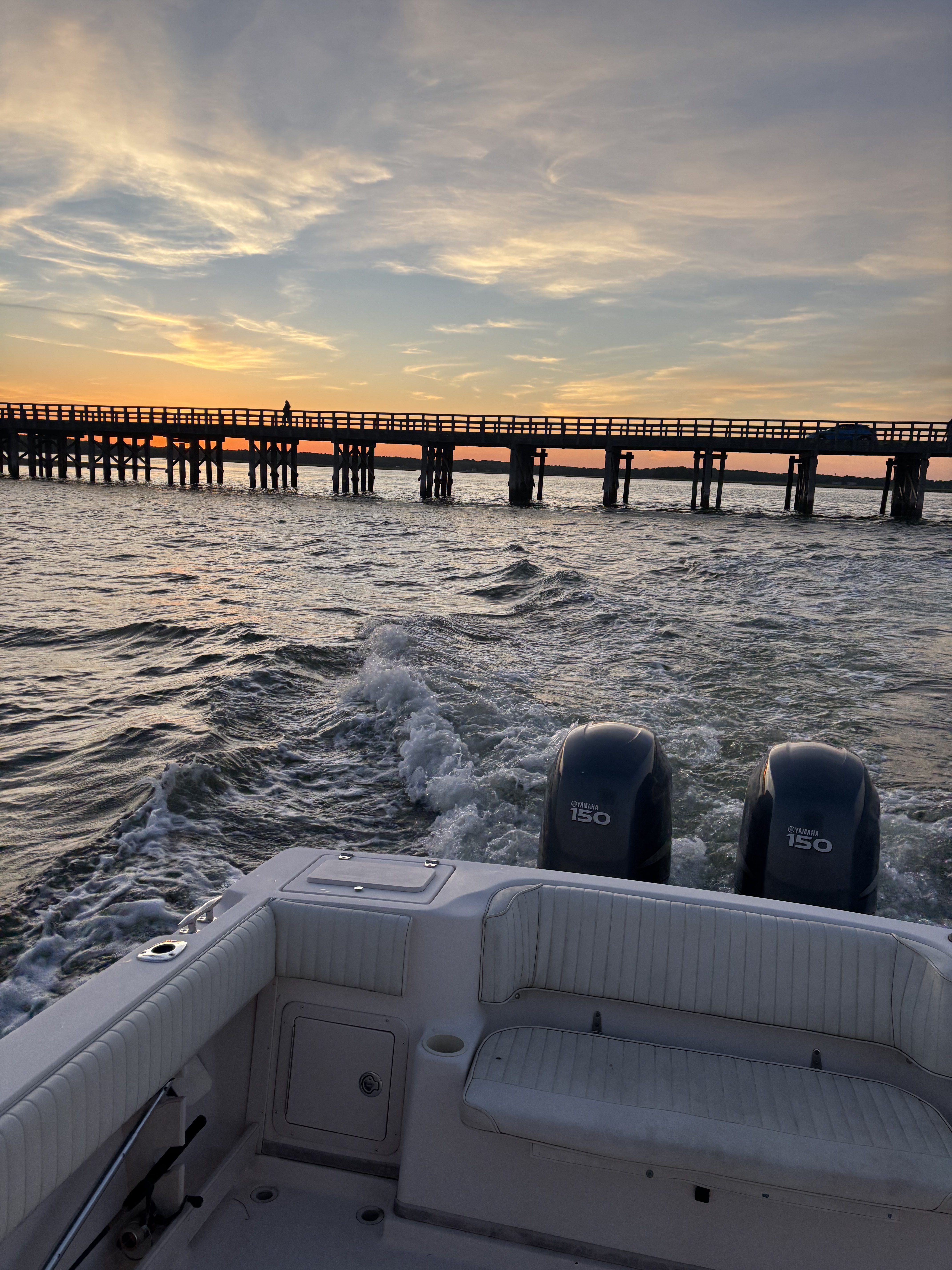 Sunset wake behind a boat heading back to the dock