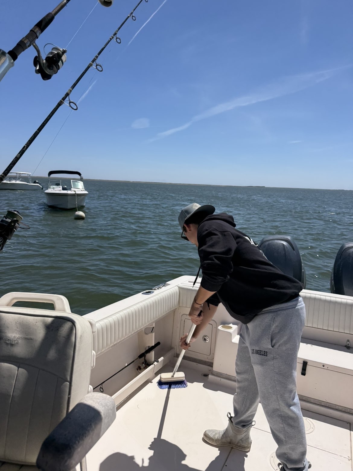 Step On & Go owner washing down a center console boat